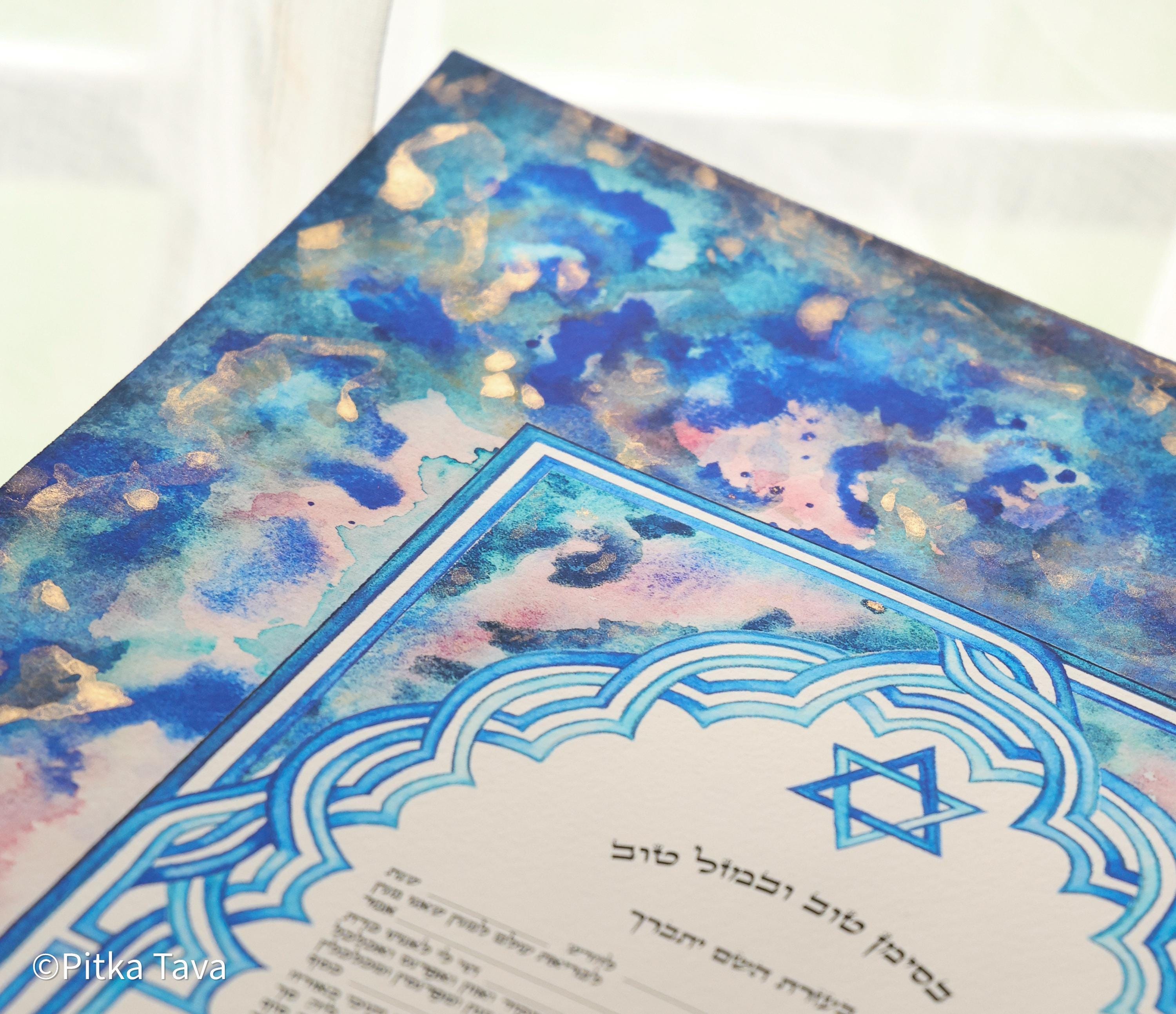 Jewish ketubah handmade for chuppah jewish wedding maroccan style with blue and white magen David colors like the Talith. Watercolor painting handmade ketubbah with sunset colors in maroccan style, unique one of a kind wedding ketubbah piece of jewish art made in israel by designer ketubbah. Illustrated blue, pink and white ketubah with sunset colors and blue and white colors around the text to remember blue colors of Am Israel.
