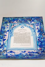 Jewish ketubah handmade for chuppah jewish wedding maroccan style with blue and white magen David colors like the Talith. Watercolor painting handmade ketubbah with sunset colors in maroccan style, unique one of a kind wedding ketubbah piece of jewish art made in israel by designer ketubbah. Illustrated blue, pink and white ketubah with sunset colors and blue and white colors around the text to remember blue colors of Am Israel.